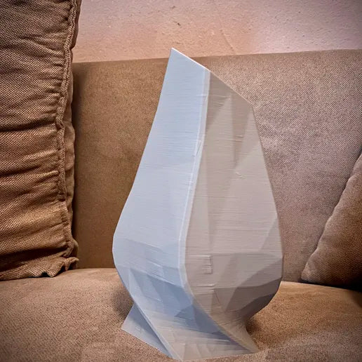 Abstract pentagon vase on sofa